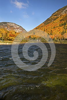 Brilliant fall foliage at Saco Lake in the White Mountains.