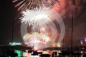 Brilliant fireworks in Sydney spread over harbor and city night scene