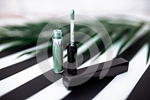 Brilliant green tube with cosmetics