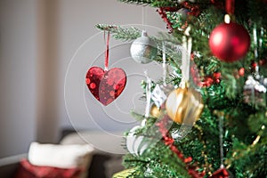 Brilliant heart hanging in christmas tree