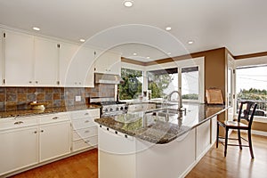 Brilliant kitchen with white accents, and marble counters.