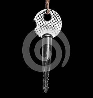 Brilliant, metallic, modern and silver key on a black saturated background. New, gray key for the entrance door, for the cabinet.