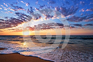 Brilliant ocean beach sunrise. Dramatic sky.