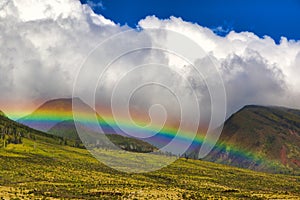 Brilliant rainbow over the lush West Maui mountains