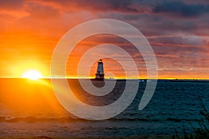 Brilliant Sunset Over Lake Behind Lighthouse