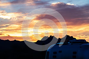 Brilliant Sunset Setting in the Desert with Camper Van