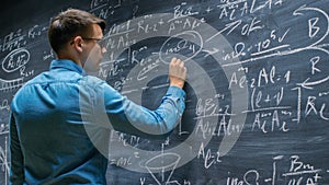 Brilliant Young Mathematician Approaches Big Blackboard and Finishes writing Sophisticated
