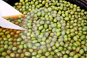 Brine olive fruits in market round pot