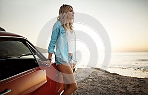 Bring on the days of bliss. a young woman enjoying a road trip along the coast.