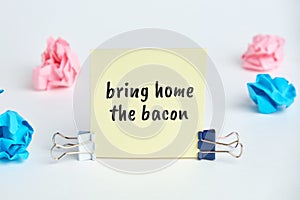 Bring home the bacon - english time idiom hand lettering on wooden blocks