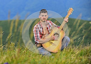 Bring Music to Life. sexy man with guitar in checkered shirt. hipster fashion. western camping and hiking. happy and