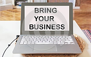 Bring your business online. text on laptop against office background