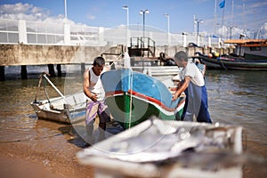 Bringing in the catch of the day. fishermen bringing in the catch of the day.