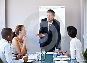 He brings clarity to the table. a businessman presenting an idea during a boardroom meeting.