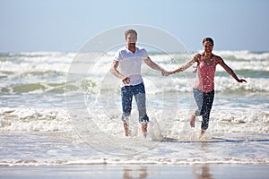 She brings out the fun in me. Shot of a young couple being playful on the beach.