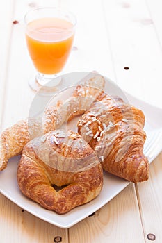 Brioches and orange juice for breakfast photo