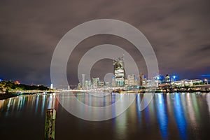 Brisbane city skyline lights across river at night from South Ba