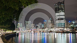 Brisbane city skyline lights across river at night from South Ba