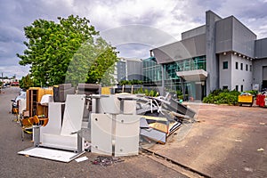 Brisbane, Queensland, Australia - Mar 4, 2022: Flood damaged office furniture dumped on the side of the road for collection