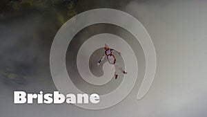 Brisbane. Skydiver from Brisbane performs a trick in the sky. Free fall.