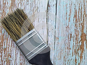 Bristle brush, wall painting, isolated on a wooden table.