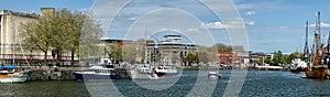 Bristol Docks with water taxis and The Matthew sailing ship, England