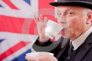 British businessman / city worker with bowler hat drinking tea.