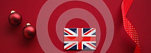 British Christmas tradition and holiday design concept. Union Jack flag of Great Britain and xmas ornaments and