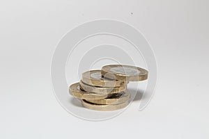 New one pound sterling coins isolated in white background, British currency monies photo