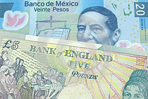 A British five pound note with a twenty Mexican peso note