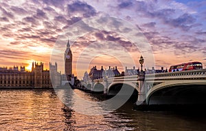 British Houses of Parliament and Big Ben in Westminster at Sunset with Red Bus, London UK