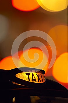 British london black taxi cab sign at night with c