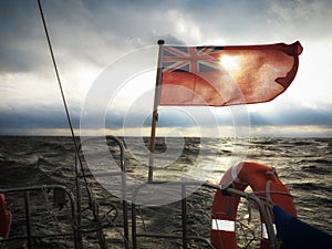 British maritime ensign flag boat and stormy sky