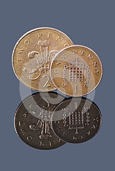 British one penny and two pence on dark background