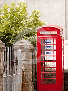 British phone booth beside a gate