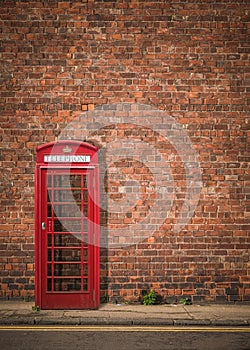 British Phonebox Against Red Brick Wall