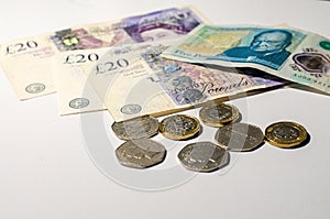 British pound coin on British pound banknotes