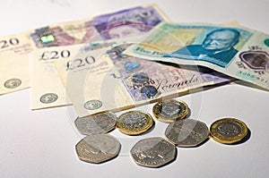 British pound coin on British pound banknotes