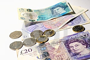 British pound coin on British pound banknotes