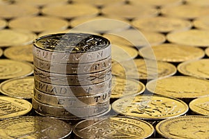 British pound coins in a neat stack.