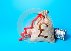 British pound sterling money bag and red up arrow. Rise in profits. Increase in the deposit rate. Increase income and business