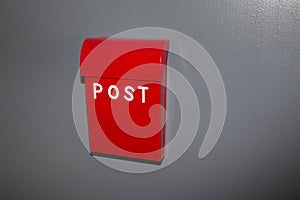 British red post box on grey wall background