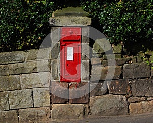 British red post box on wall