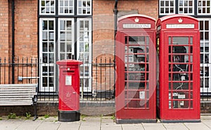 British red telephone booths beside a red post box in Stratford upon Avon, Warwickshire, England UK