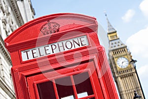 British red telephone box with Big Ben clock tower in distance, London, UK