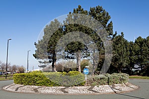 British roundabout with brick chevrons and bushes in the centre Birkenhead Wirral April 2019