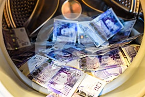 British Sterling Pounds Notes In Washing Machine. Money Laundering Concept