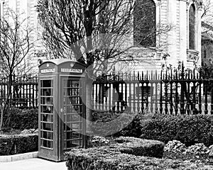 British telephone booth outside churchyard in London