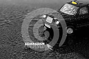 British traditional black cab taxi toy car with the word hire on beads