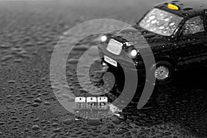 British traditional black cab taxi toy car with the word tip on beads